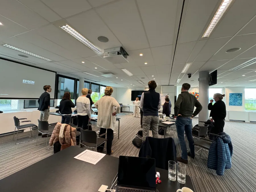 Valorize Solutions Body Speak workshop: a group works standing up on posture and presence in a training room.