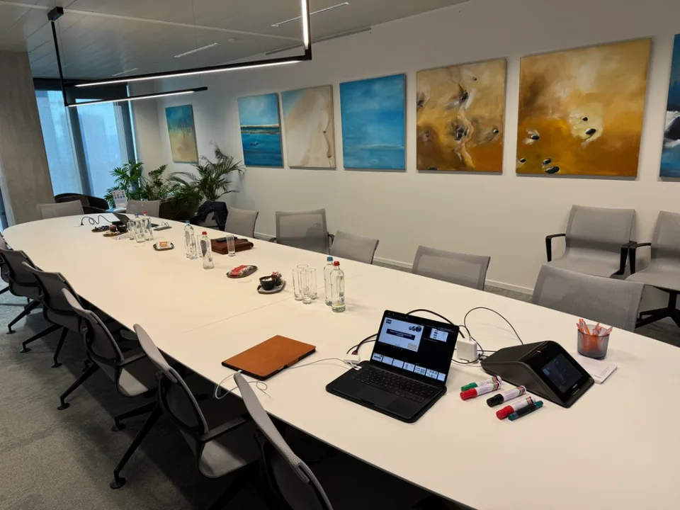 Boardroom set up for a leadership working session with Valorize Solutions: laptops open and markers on the table.